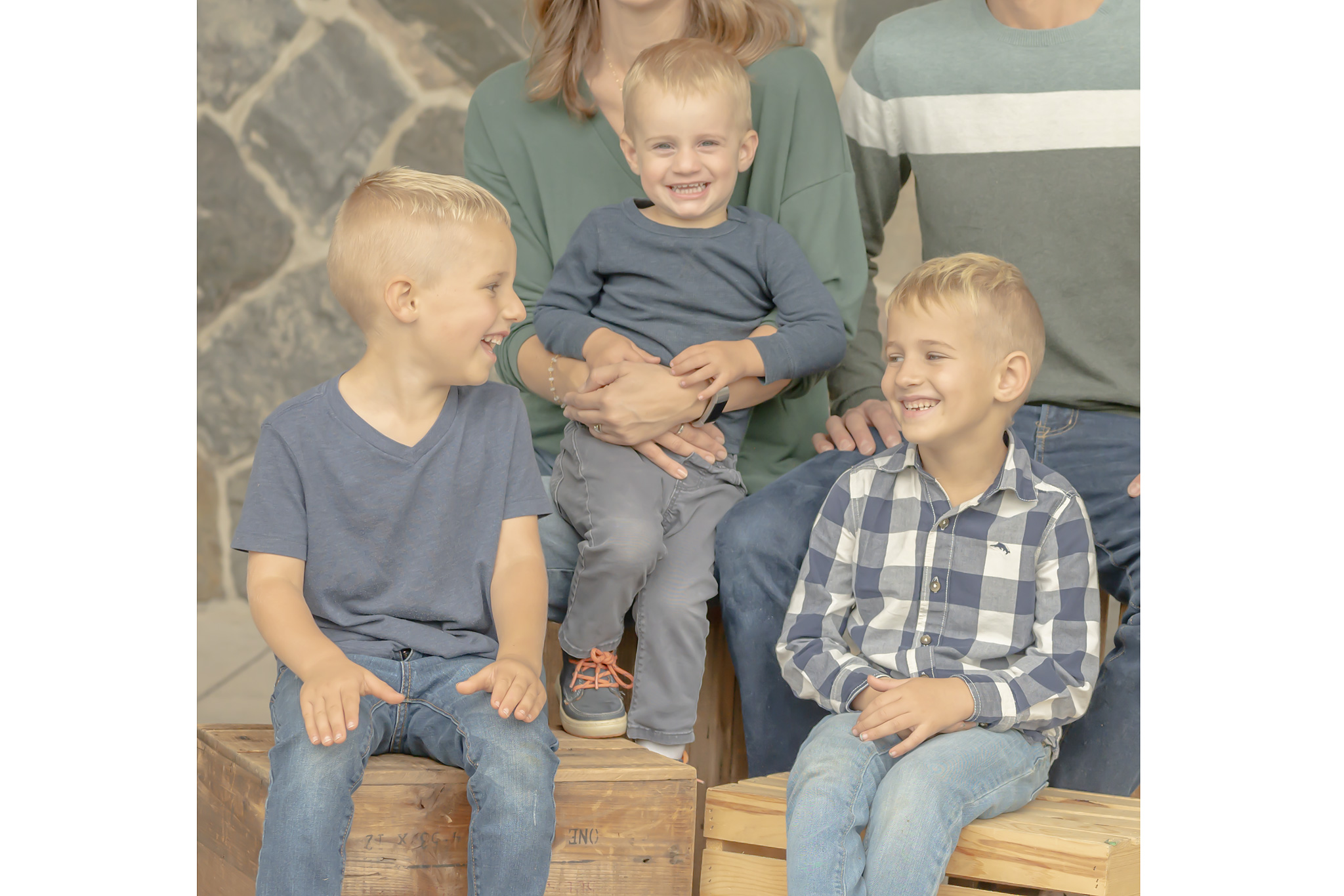 Professional family portrait session with siblings interacting