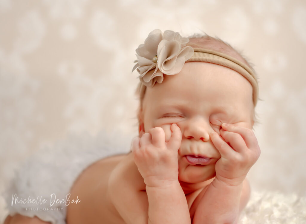 Detailed newborn photography in a soft, neutral studio setting, highlighting tiny toes and delicate features for a custom-framed heirloom.