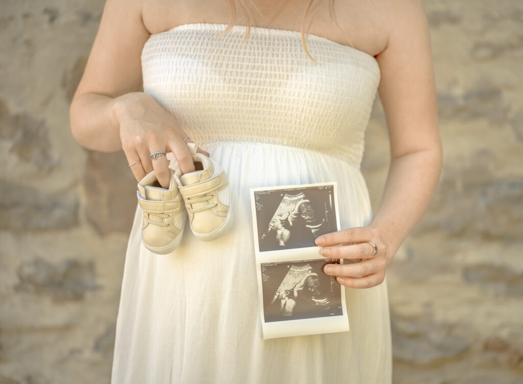 Maternity session in St. Catharines featuring soon to be mom with little booties and ultrasound photo.