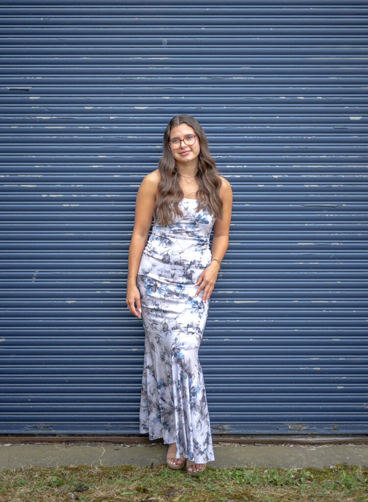 Teen graduation photo with urban wall