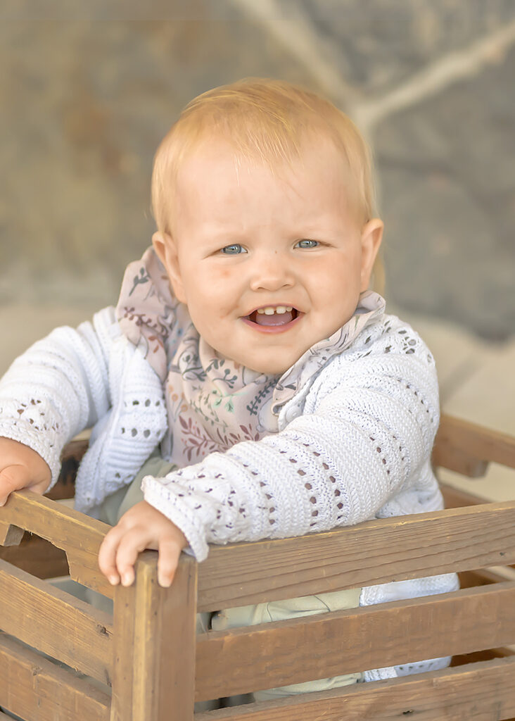 Individual portrait of toddler outdoors in green space